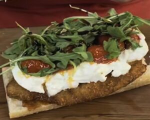 Fried Pork Cutlet with tomatoes, arugula, and burrata